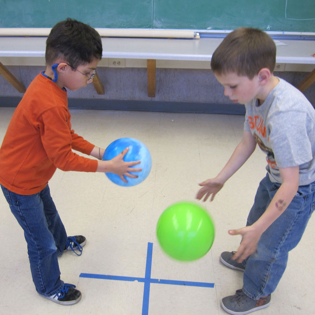 two boy playing with balls
